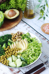 A bowl with a salad made of green vegetables