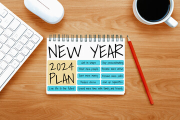 2024 Happy New Year Resolution Goal List and Plans Setting - Business office desk with notebook written about plan listing of new year goals and resolutions setting. Change and bliss concept. - obrazy, fototapety, plakaty