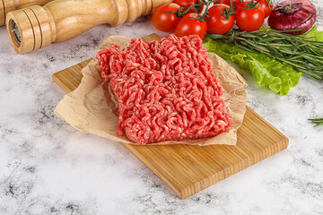 Raw minced beef meat on cutting board