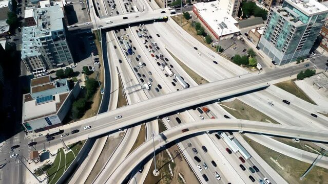 Overhead drone footage of cars driving over elevated highway and busy interchange in Chicago