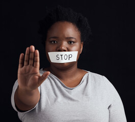 Portrait, stop and palm with a black woman in studio on a black background for gender equality or...