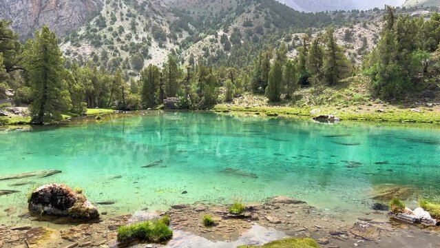 The Alaudin (Chapdara) lakes, lying at an altitude of 2800 m, are considered one of the most beautiful lakes of the Fan Mountains. Turquoise mountain lake. Pamiro-Alai. Tajikistan, Pamir 4K