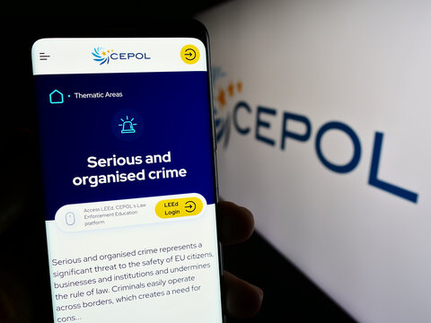 Stuttgart, Germany - 10-17-2023: Person holding cellphone with webpage of European Union Agency for Law Enforcement Training (CEPOL) with logo. Focus on center of phone display.