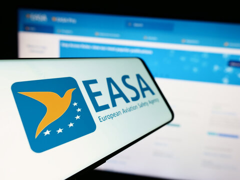 Stuttgart, Germany - 10-17-2023: Cellphone with logo of European Union Aviation Safety Agency (EASA) in front of website. Focus on center-left of phone display.