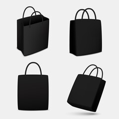 Set of black paper shopping bags, isolated.