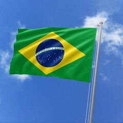 Brazil flag fluttering in the wind on sky.