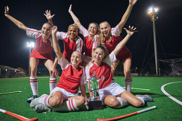 Soccer, trophy and women on a field at night to celebrate teamwork, winning and sports. Football,...