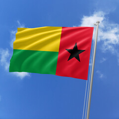 Guinea Bissau flag fluttering in the wind on sky.