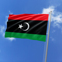 Libya flag fluttering in the wind on sky.