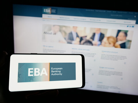 Stuttgart, Germany - 10-20-2023: Person holding smartphone with logo of EU institution European Banking Authority (EBA) in front of website. Focus on phone display.