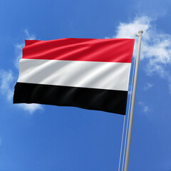 Yemen flag fluttering in the wind on sky.