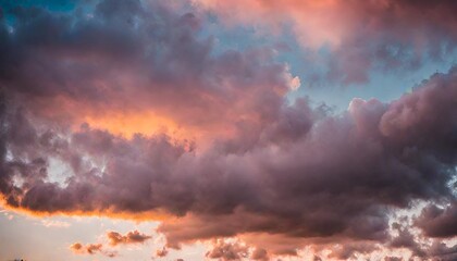 Fototapeta na wymiar Toned dramatic sky background. Blue gray sky with orange pink clouds. Cloudscape. Fantastic sunset.