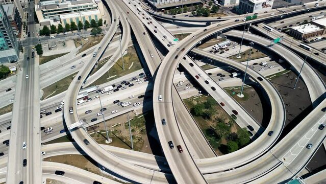 wide aerial shot of cars driving over elevated highway and busy interchange near Chicago