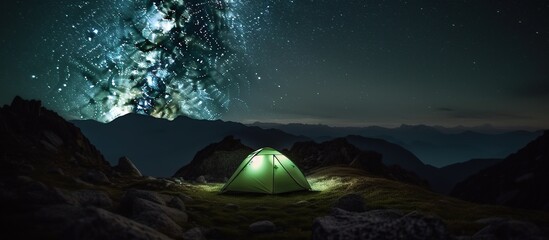 Camping at night, under the stars, outdoors. Green tent over mountains - obrazy, fototapety, plakaty