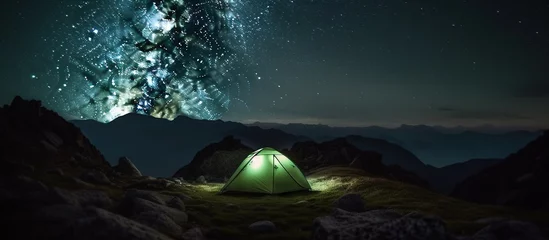 Papier Peint photo Camping Camping at night, under the stars, outdoors. Green tent over mountains