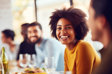 African American family having dinner during thanksgiving day. Happy people celebrating holiday, eating and laughing together