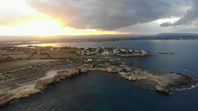 Wide view of ruins Punta della mola at Sicily during sunset, aerial