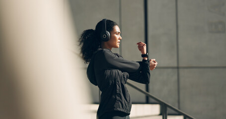 Runner woman, headphones and warm up on stairs for music, vision and ideas in city, workout and...