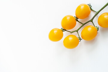Yellow tomatoes on a white background