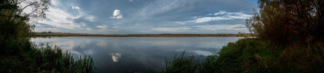 Panorama. Dusk on the lake. Rainy day near the lake.