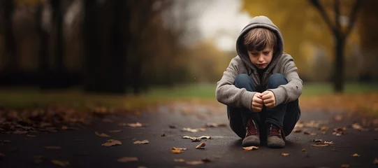 Fotobehang sad depressed young boy child sit in your room. © dashtik
