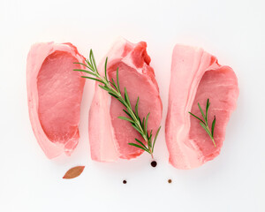 Food concept. Fresh pork meat tenderloin close-up with sprig of rosemary, bay leaf, black peppercorns, garlic for barbecue grilling of dishes on white background isolate Healthy food. Vitamins protein