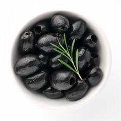 Delicious black olives in plate with olive tree sprig decoration isolated on white background top view for your design. Healthy eating, healthy fats for humans. Organic vegetable