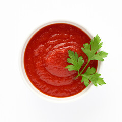 Red tomato ketchup sauce for meat dishes in plate isolated on white background decorated with green sprig of parsley for your design top view. Healthy eating