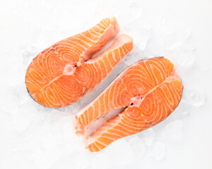 Fresh salmon steaks sea fish peeled laid out on pieces of ice isolated on white background top view for your design. Healthy food. Vitamins, Omega B12 healthy fats for human health. 