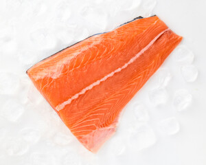 Fresh salmon fillet sea fish peeled laid out on pieces of ice isolated on white background top view for your design. Healthy food. Vitamins, Omega B12 healthy fats for human health. 