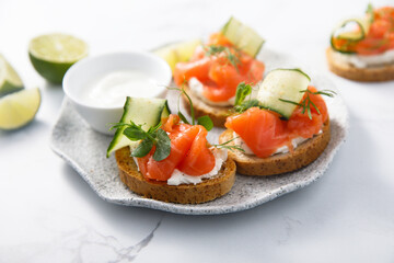 Homemade crostini with smoked salmon and cucumber