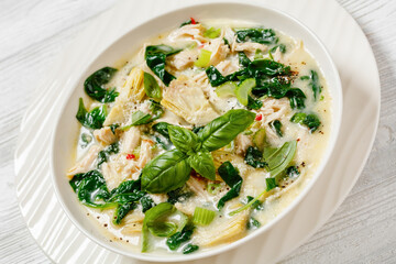 chicken spinach artichoke creamy soup in a bowl