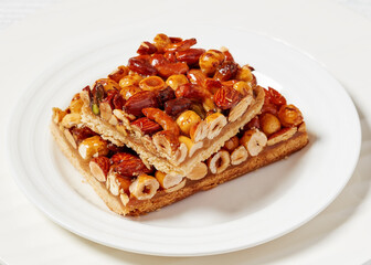 toffee mixed nuts shortbread bars on white plate
