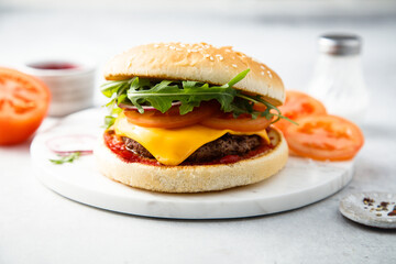 Traditional homemade cheeseburger with arugula