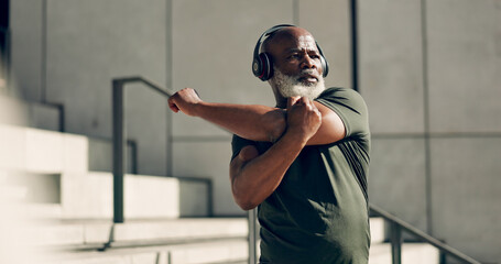 Fitness, headphones and senior black man stretching in city, workout and exercise for body health....