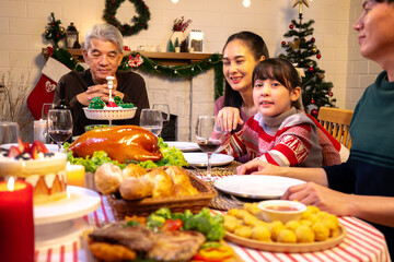Happy people are celebrating on a table meal when christmas and new year at home.
