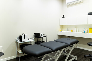 Photo of a physiotherapy room with no people. Physiotherapy room with equipment. Physio centre with tools to do sessions.