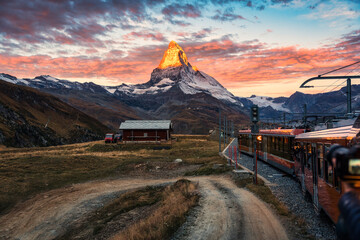 View of sunrise on Matterhorn mountain during the train ride up to Gornergrat at Zermatt,...