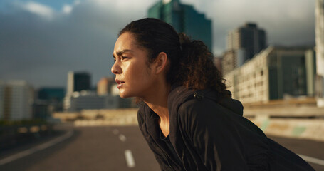 Woman, runner and breathe in road for fitness, exercise or wellness with city background or nature....