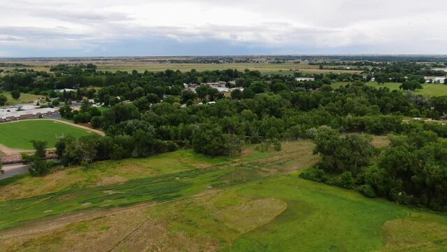 Immersive drone video of a rural paradise with endless greenery, serene plains, and majestic clouds in the horizon.