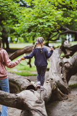 mother with her child hand in hand in the forest park in varna bulgaria 