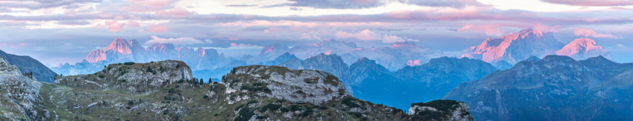 View of pink mountain peaks at sunrise from Falzarego pass, South Tyrol, Dolomites, Italy
