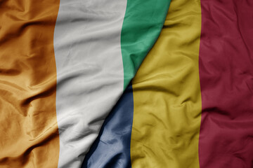 big waving national colorful flag of cote divoire and national flag of chad .