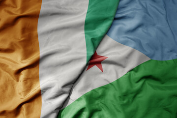Obraz premium big waving national colorful flag of cote divoire and national flag of djibouti .
