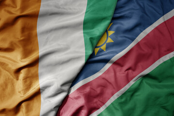 big waving national colorful flag of cote divoire and national flag of namibia .