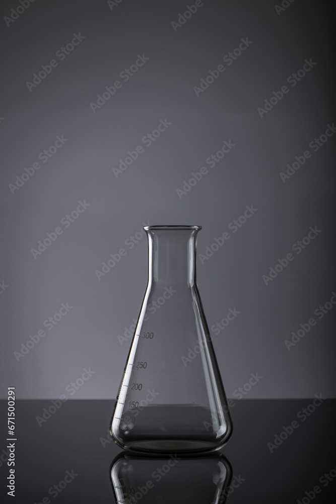 Aufkleber vertical image of close up of laboratory beaker and copy space on grey background