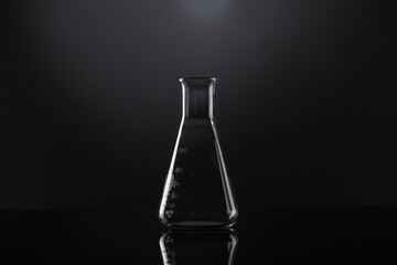 Close up of laboratory beaker and copy space on black background