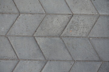 Close shot of gray diamond shaped concrete pavement with geometric pattern