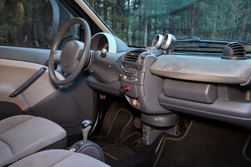 Shift lever, car steering wheel and sensors. Inside a modern car view, city car interior background