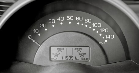 Car speedometer and sensors on a control panel background, car elements close view